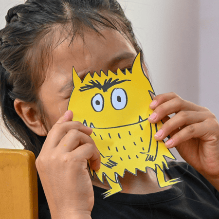 Girl playing with drawing at NPH Peru