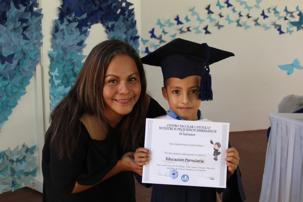 Pablo holding his diploma NPH El Salvador